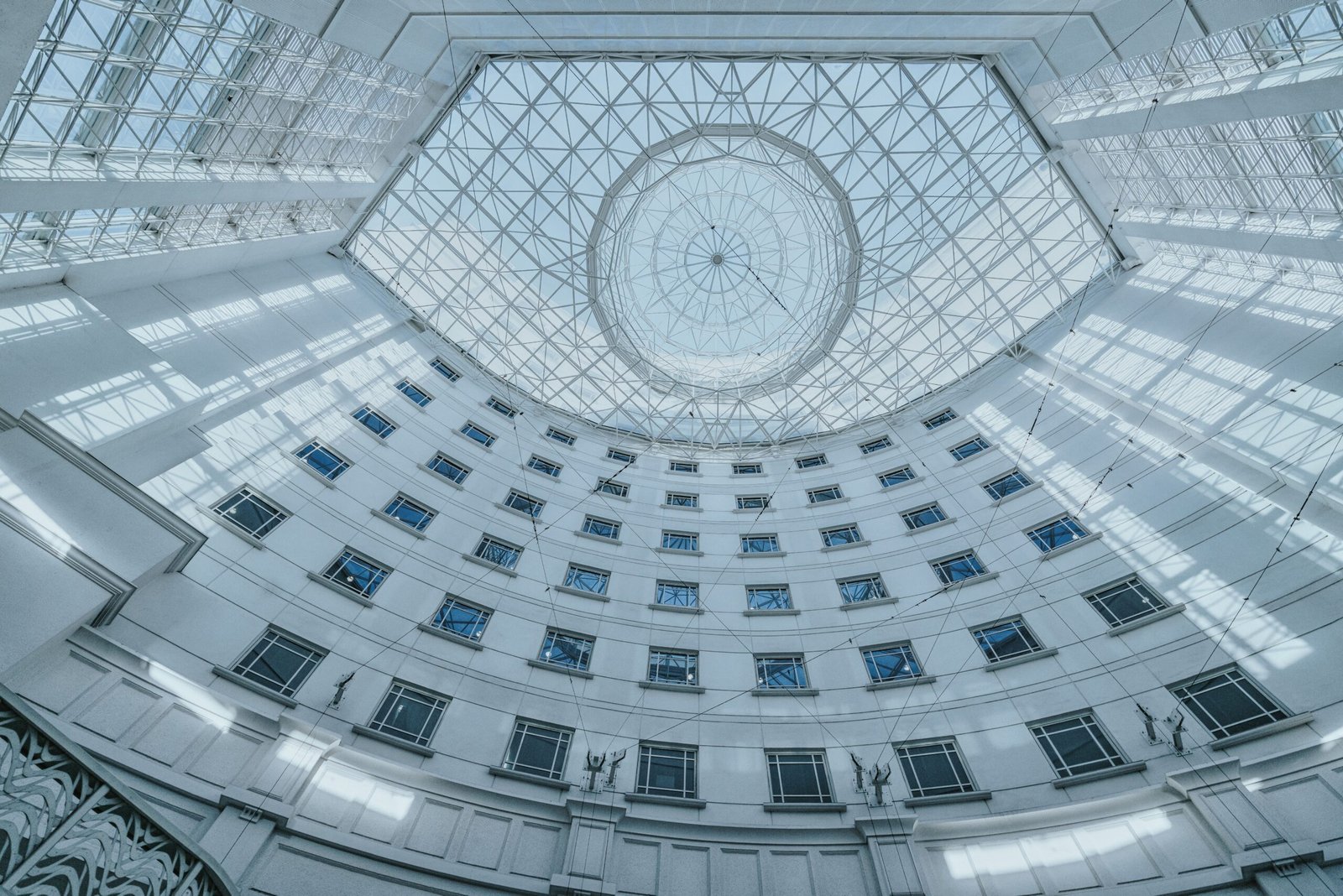 Modern architectural design with a glass skylight in a Singapore atrium, showcasing urban elegance.